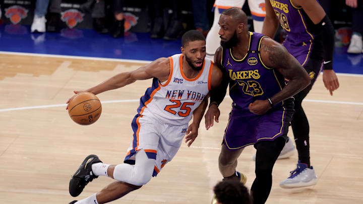 Feb 1, 2025; New York, New York, USA; New York Knicks forward Mikal Bridges (25) drives to the basket against Los Angeles Lakers forward LeBron James (23) during the first quarter at Madison Square Garden. Mandatory Credit: Brad Penner-Imagn Images