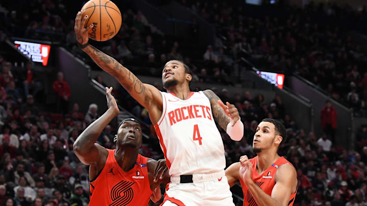 Jan 18, 2025; Portland, Oregon, USA;  Houston Rockets guard Jalen Green (4) drives to the hoop against Portland Trail Blazers center Duop Reath (26) and forward Kris Murray (24) during the first half at Moda Center. Mandatory Credit: Brian Murphy-Imagn Images