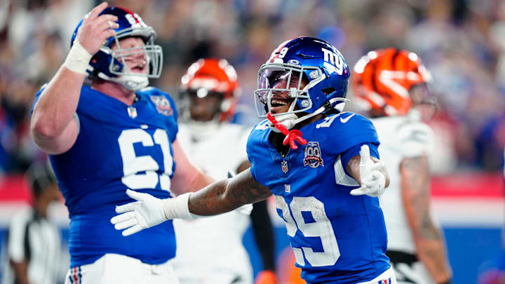 New York Giants running back Tyrone Tracy Jr. (29) celebrates his third-quarter touchdown beside teammate New York Giants center John Michael Schmitz Jr. (61), Sunday, October 13, 2024, in East Rutherford.