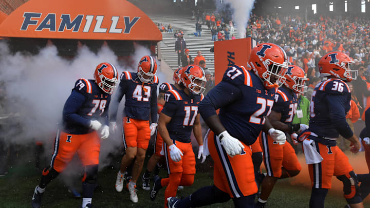 Nov 16, 2024; Champaign, Illinois, USA;  Illinois fighting Illini players take the field against the Michigan State Spartans at Memorial Stadium. Mandatory Credit: Ron Johnson-Imagn Images
