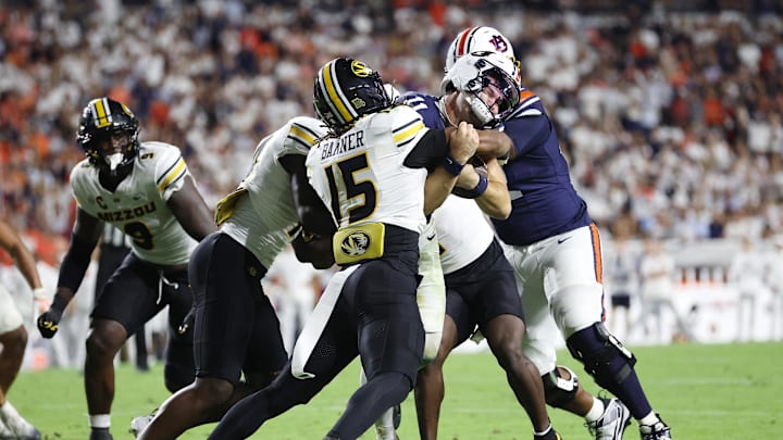 Oct 18, 2025; Auburn, Alabama, USA;  Missouri Tigers safety Santana Banner (15) tackles Auburn Tigers quarterback Jackson Arnold (11) during the third quarter at Jordan-Hare Stadium.  Mandatory Credit: John Reed-Imagn Images