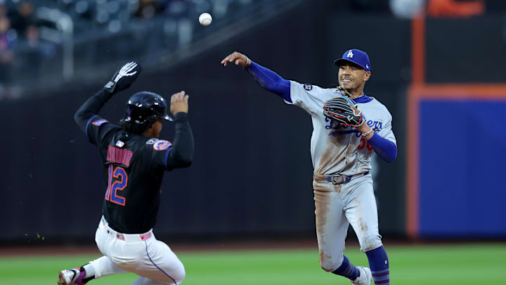 May 23, 2025; New York City, New York, USA; Los Angeles Dodgers shortstop Mookie Betts (50) forces out New York Mets shortstop Francisco Lindor (12) at second base then throws to first to complete a double play on a ball hit by Mets right fielder Juan Soto (not pictured) during the first inning at Citi Field. Mandatory Credit: Brad Penner-Imagn Images