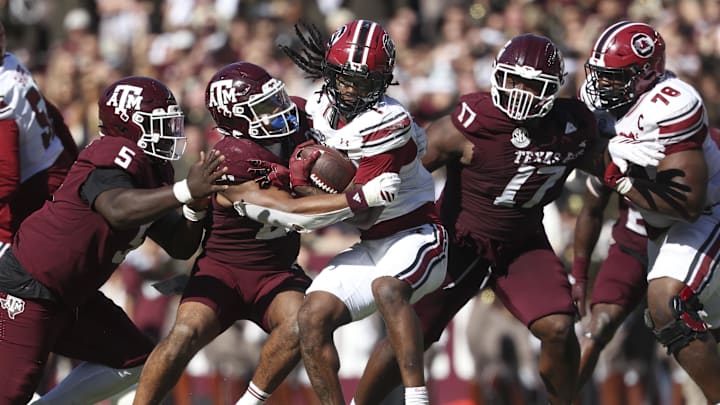Nov 15, 2025; College Station, Texas, USA; Texas A&M Aggies linebacker Taurean York (21) tackles South Carolina Gamecocks running back Rahsul Faison (1) during the third quarter at Kyle Field. Mandatory Credit: Troy Taormina-Imagn Images