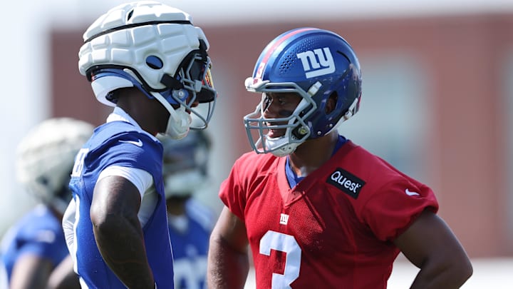 New York Giants quarterback Russell Wilson (3) talks with wide receiver Malik Nabers (1) during training camp.