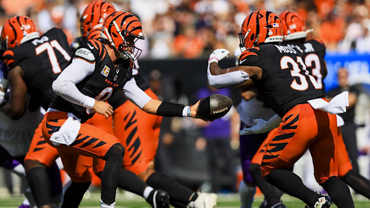 Oct 6, 2024; Cincinnati, Ohio, USA; Cincinnati Bengals quarterback Joe Burrow (9) hands the ball off to running back Zack Moss (31) in the first half against the Baltimore Ravens at Paycor Stadium. Mandatory Credit: Katie Stratman-Imagn Images