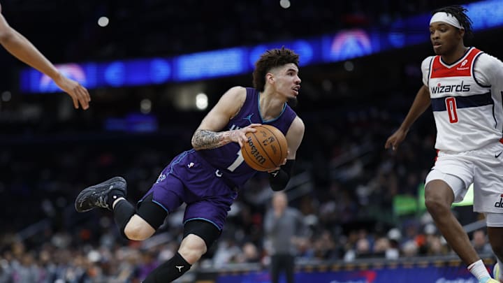 Dec 19, 2024; Washington, District of Columbia, USA; Charlotte Hornets guard LaMelo Ball (1) drives to the basket as Washington Wizards guard Bilal Coulibaly (0) defends in the second quarter at Capital One Arena. Mandatory Credit: Geoff Burke-Imagn Images