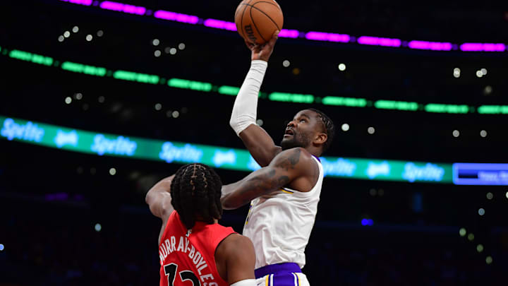 Jan 18, 2026; Los Angeles, California, USA; Los Angeles Lakers center Deandre Ayton (5) shoots against Toronto Raptors forward Collin Murray-Boyles (12) during the first half at Crypto.com Arena. Mandatory Credit: Gary A. Vasquez-Imagn Images