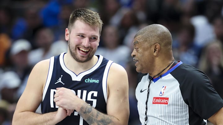 Nov 8, 2024; Dallas, Texas, USA;  Dallas Mavericks guard Luka Doncic (77) laughs with referee Tony Brothers (25) during the third quarter against the Phoenix Suns at American Airlines Center. Mandatory Credit: Kevin Jairaj-Imagn Images
