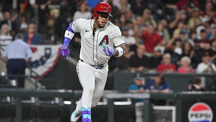 Mar 28, 2025; Phoenix, Arizona, USA;  Arizona Diamondbacks second base Ketel Marte (4) doubles in the seventh inning against the Chicago Cubs at Chase Field. Mandatory Credit: Matt Kartozian-Imagn Images