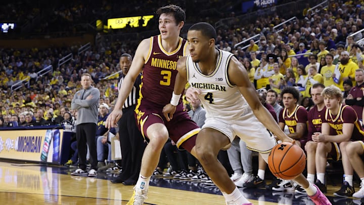 Feb 24, 2026; Ann Arbor, Michigan, USA; Michigan Wolverines guard Nimari Burnett (4) dribbles against Minnesota Golden Gophers forward Bobby Durkin (3) in the first half at Crisler Center. Mandatory Credit: Rick Osentoski-Imagn Images