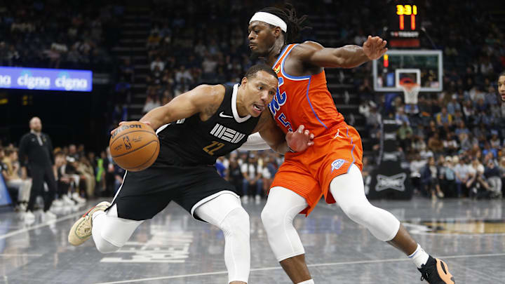 Mar 16, 2024; Memphis, Tennessee, USA; Memphis Grizzlies guard Desmond Bane (22) drives to the basket as Oklahoma City Thunder guard Luguentz Dort (5) defends during the second half at FedExForum. Mandatory Credit: Petre Thomas-Imagn Images Mar 16, 2024; Memphis, Tennessee, USA; Memphis Grizzlies guard Desmond Bane (22) drives to the basket as Oklahoma City Thunder guard Luguentz Dort (5) defends during the second half at FedExForum. Mandatory Credit: Petre Thomas-Imagn Images