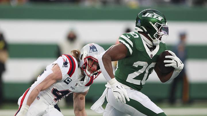 Dec 28, 2025; East Rutherford, New Jersey, USA; New York Jets running back Breece Hall (20) runs for a touchdown against New England Patriots safety Brenden Schooler (41) during the second half of the game at MetLife Stadium.  Mandatory Credit: Vincent Carchietta-Imagn Images