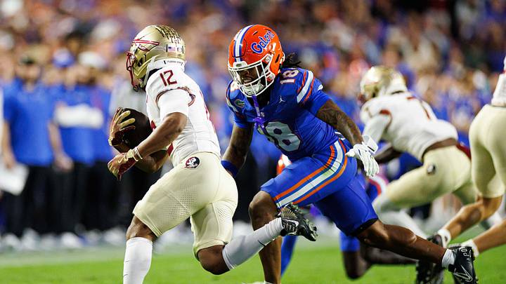 Nov 29, 2025; Gainesville, Florida, USA; Florida Gators safety Bryce Thornton (18) looks to tackle Florida State Seminoles running back Jaylin Lucas (12) during the first half at Ben Hill Griffin Stadium. Mandatory Credit: Matt Pendleton-Imagn Images
