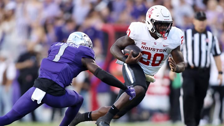 Oct 4, 2024; Fort Worth, Texas, USA; Houston Cougars running back J'Marion Burnette (20) runs the ball against TCU Horned Frogs safety Abe Camara (1) in the first quarter at Amon G. Carter Stadium. 