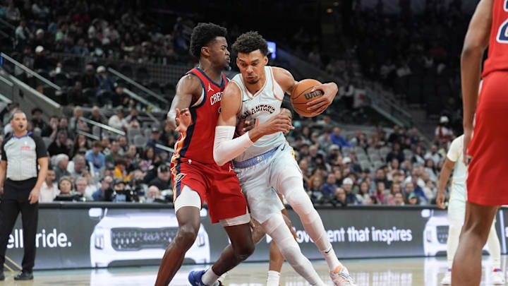 Dec 8, 2024; San Antonio, Texas, USA;  San Antonio Spurs center Victor Wembanyama (1) dribbles against New Orleans Pelicans center Yves Missi (21) in the second half at Frost Bank Center. Mandatory Credit: Daniel Dunn-Imagn Images