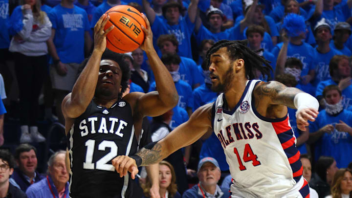Feb 15, 2025; Oxford, Mississippi, USA; Mississippi State Bulldogs guard Josh Hubbard (12) drives to the basket as Mississippi Rebels guard Dre Davis (14) defends during the first half at The Sandy and John Black Pavilion at Ole Miss. Mandatory Credit: Petre Thomas-Imagn Images