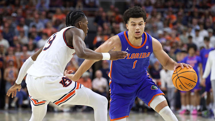 Feb 8, 2025; Auburn, Alabama, USA;  Florida Gators guard Walter Clayton Jr. (1) runs a play as Auburn Tigers guard Miles Kelly (13) defends during the first half at Neville Arena. Mandatory Credit: John Reed-Imagn Images