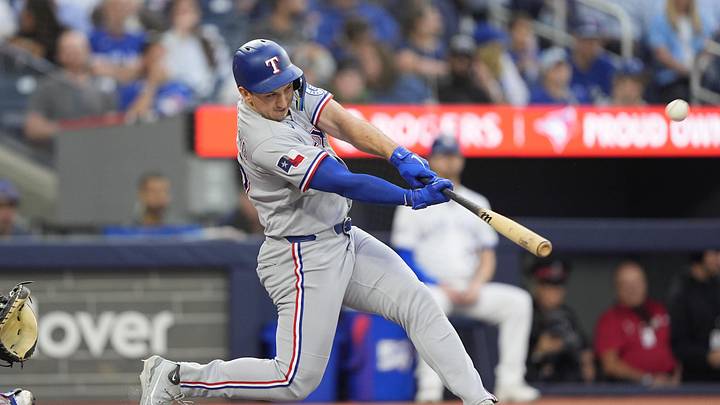 Jun 25, 2026; Toronto, Ontario, CAN; Texas Rangers center fielder Wyatt Langford (36) hits a three run home run against the Toronto Blue Jays during the third inning at Rogers Centre. Mandatory Credit: John E. Sokolowski-Imagn Images