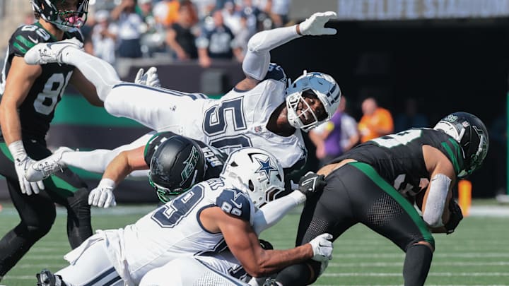 New York Jets wide receiver Quentin Skinner is tackled by Dallas Cowboys' Brevyn Spann-Ford and Shemar James 
