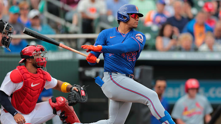 Feb 24, 2025; Jupiter, Florida, USA; New York Mets right fielder Juan Soto (22) hits a single against the St. Louis Cardinals during the third inning at Roger Dean Chevrolet Stadium. Mandatory Credit: Sam Navarro-Imagn Images