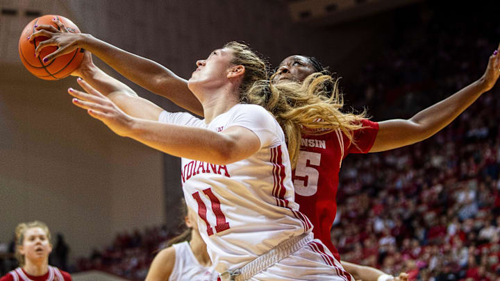 Indiana's Karoline Striplin (11) is blocked by Wisconsin's Serah Williams (25) during the Indiana versus Wisconsin women's basketball game at Simon Skjodt Assembly Hall on Saturday, Dec. 28, 2024. Indiana's Karoline Striplin (11) is blocked by Wisconsin's Serah Williams (25) during the Indiana versus Wisconsin women's basketball game at Simon Skjodt Assembly Hall on Saturday, Dec. 28, 2024.