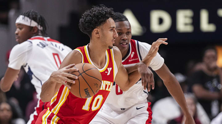 Oct 28, 2024; Atlanta, Georgia, USA; Atlanta Hawks forward Zaccharie Risacher (10) dribbles against Washington Wizards guard Carlton Carrington (8) during the first half at State Farm Arena. Mandatory Credit: Dale Zanine-Imagn Images