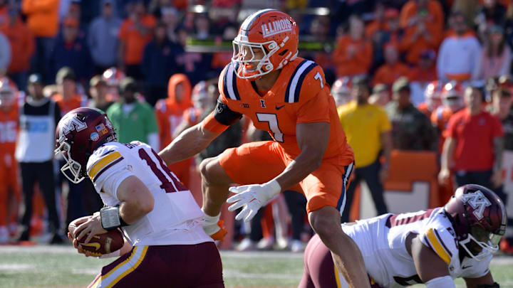 Nov 2, 2024; Champaign, Illinois, USA;  Illinois Fighting Illini defensive back Matthew Bailey (7) tackles Minnesota Golden Gophers quarterback Max Brosmer (16) during the second half at Memorial Stadium. Mandatory Credit: Ron Johnson-Imagn Images