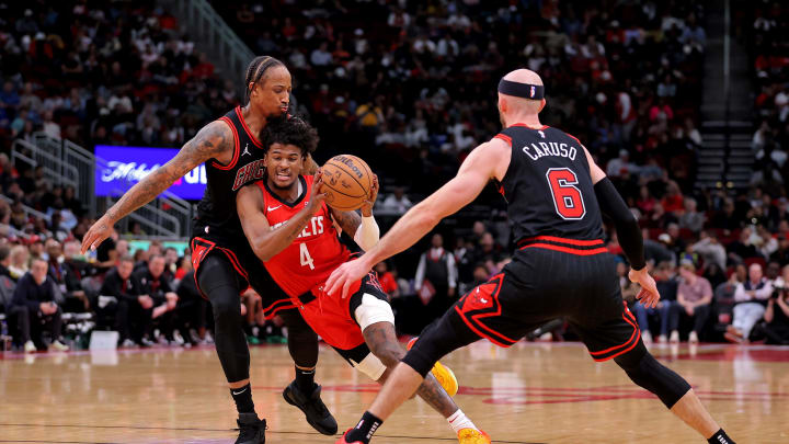 Mar 21, 2024; Houston, Texas, USA; Houston Rockets guard Jalen Green (4) drives to the basket against Chicago Bulls forward DeMar DeRozan (11) and Chicago Bulls guard Alex Caruso (6) during the third quarter at Toyota Center. Mandatory Credit: Erik Williams-USA TODAY Sports

