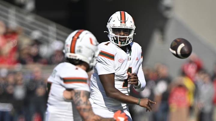 Oct 19, 2024; Louisville, Kentucky, USA; Miami Hurricanes quarterback Cam Ward (1) passes to wide receiver Xavier Restrepo (7) against the Louisville Cardinals during the first quarter at L&N Federal Credit Union Stadium. Mandatory Credit: Jamie Rhodes-Imagn Images