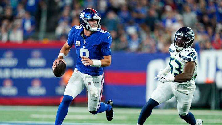 New York Giants quarterback Daniel Jones (8) runs with the ball with pressure from Seattle Seahawks linebacker Boye Mafe (53). The Seahawks defeat the Giants, 24-3, at MetLife Stadium on Monday, Oct. 2, 2023, in East Rutherford.