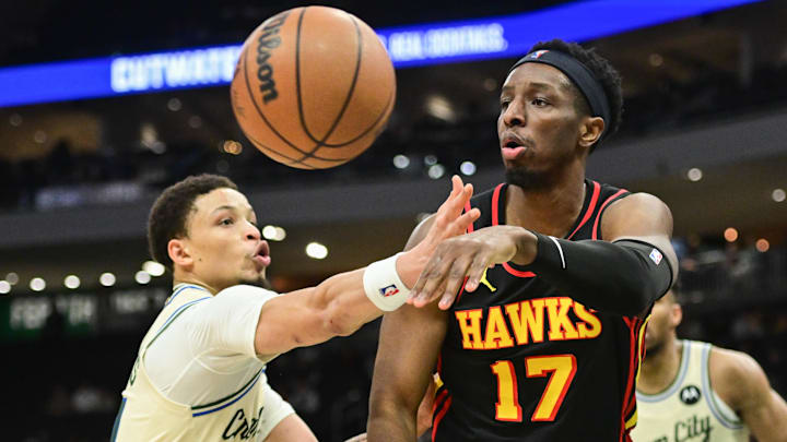 Mar 4, 2026; Milwaukee, Wisconsin, USA; Atlanta Hawks center Onyeka Okongwu (17) passes the ball away from Milwaukee Bucks guard Ryan Rollins (13) in the fourth quarter at Fiserv Forum. Mandatory Credit: Benny Sieu-Imagn Images