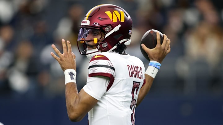 Jan 5, 2025; Arlington, Texas, USA; Washington Commanders quarterback Jayden Daniels (5) throws a pass against the Dallas Cowboys during the first quarter at AT&T Stadium. Mandatory Credit: Tim Heitman-Imagn Images