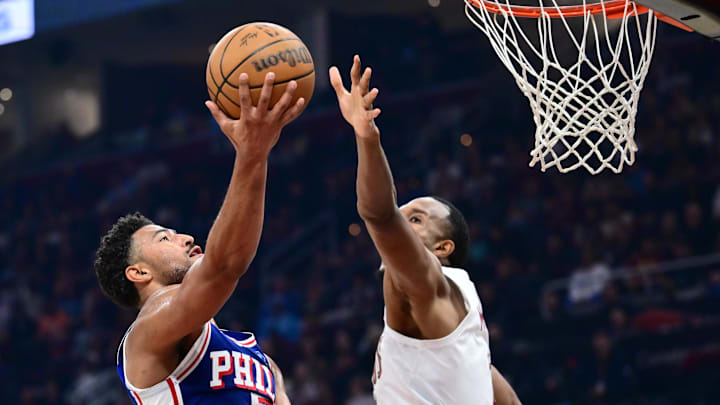 Mar 9, 2026; Cleveland, Ohio, USA; Philadelphia 76ers guard Quentin Grimes (5) drives to the basket against Cleveland Cavaliers center Evan Mobley (4) during the first half at Rocket Arena. Mandatory Credit: Ken Blaze-Imagn Images
