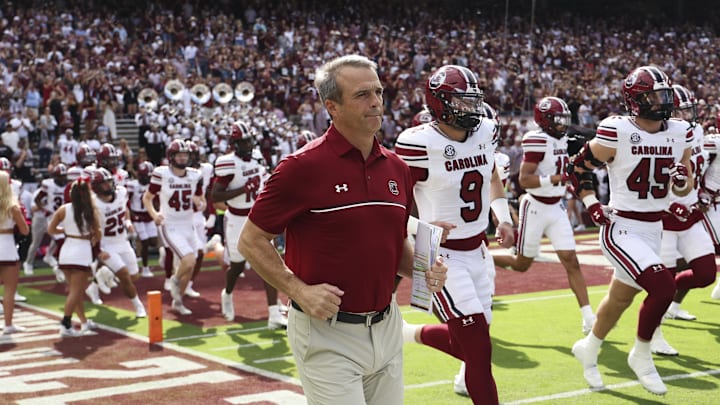 Nov 15, 2025; College Station, Texas, USA; South Carolina Gamecocks head coach Shane Beamer runs onto the field with players before the game against the Texas A&M Aggies at Kyle Field. Mandatory Credit: Troy Taormina-Imagn Images
