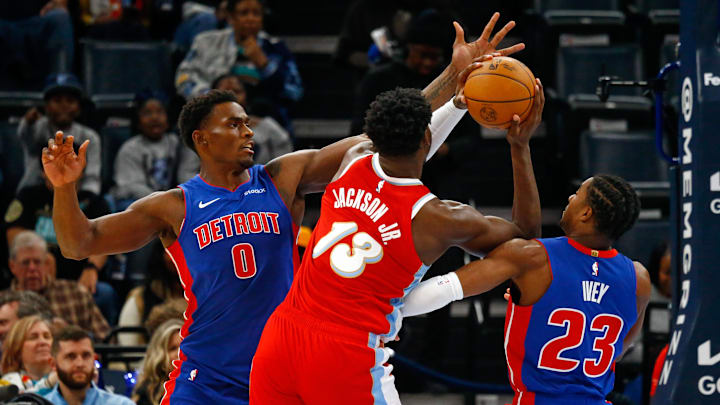 Nov 27, 2024; Memphis, Tennessee, USA; Detroit Pistons center Jalen Duren (0) and guard Jaden Ivey (23) defend as Memphis Grizzlies forward Jaren Jackson Jr. (13) drives to the basket during the first quarter at FedExForum. Mandatory Credit: Petre Thomas-Imagn Images