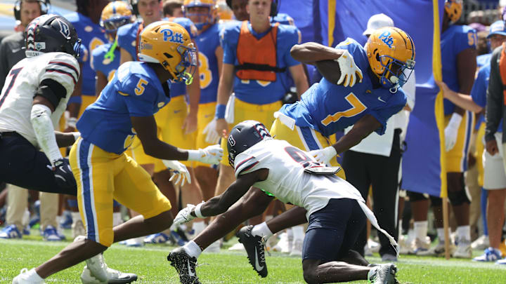 Aug 30, 2025; Pittsburgh, Pennsylvania, USA; Pittsburgh Panthers wide receiver Deuce Spann (7) runs after a catch against Duquesne Dukes defensive back Joel Kpassou (8) during the second quarter at Acrisure Stadium. Mandatory Credit: Charles LeClaire-Imagn Images