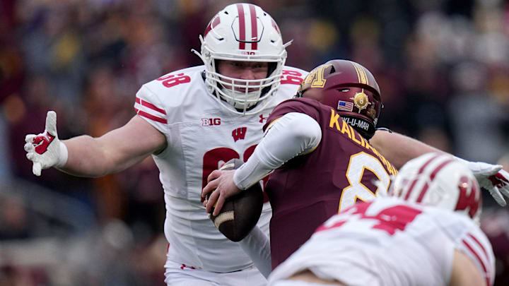 Wisconsin defensive end Ben Barten (68) sacks Minnesota quarterback Athan Kaliakmanis (8) during the first quarter of their game Saturday, November 25, 2023 at Huntington Bank Stadium in Minneapolis, Minnesota. Wisconsin beat Minnesota 28-14.
