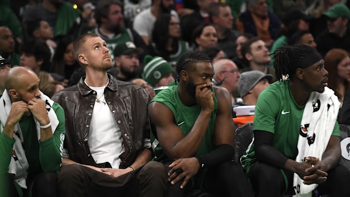 Jan 27, 2024; Boston, Massachusetts, USA;  Boston Celtics center Kristaps Porzingis (8) guard Jaylen Brown (7) and guard Jrue Holiday (4) on the bench during the second half against the LA Clippers at TD Garden. Mandatory Credit: Bob DeChiara-Imagn Images