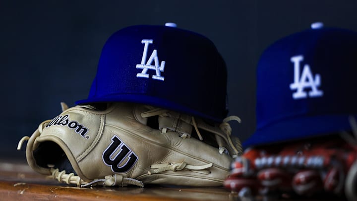 Jul 30, 2025; Cincinnati, Ohio, USA; A general view of a Los Angeles Dodgers hat and glove during the second inning in the game against the Cincinnati Reds at Great American Ball Park. Mandatory Credit: Katie Stratman-Imagn Images