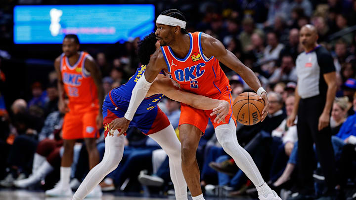 Feb 1, 2026; Denver, Colorado, USA; Oklahoma City Thunder guard Shai Gilgeous-Alexander (2) controls the ball under pressure from Denver Nuggets guard Julian Strawther (3) in the fourth quarter at Ball Arena. Mandatory Credit: Isaiah J. Downing-Imagn Images