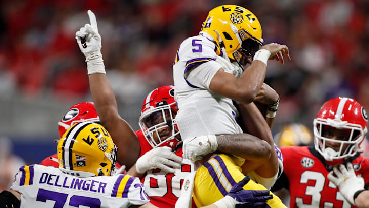 Georgia defensive lineman Jalen Carter (88) holds LSU quarterback Jayden Daniels (5) in the air in celebration after sacking Daniels during the first half of the SEC Championship NCAA college football game between LSU and Georgia in Atlanta, on Saturday, Dec. 3, 2022.

News Joshua L Jones