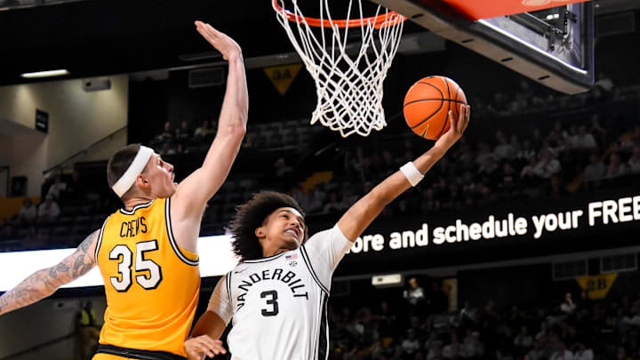 Vanderbilt Commodores guard Tyler Tanner (3) lays the ball in under the arm of Missouri Tigers guard Jacob Crews (35) during the first half at Memorial Gymnasium. Vanderbilt Commodores guard Tyler Tanner (3) lays the ball in under the arm of Missouri Tigers guard Jacob Crews (35) during the first half at Memorial Gymnasium.