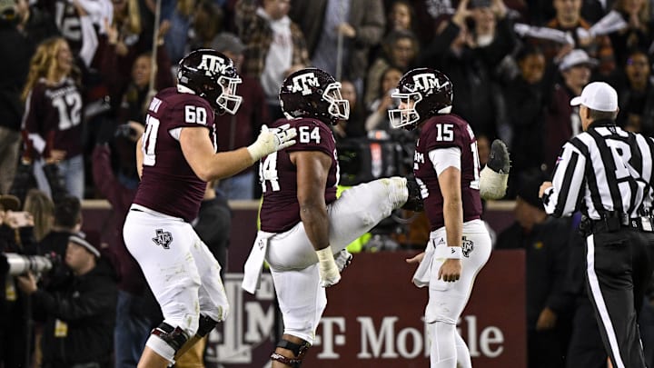 Texas A&M Aggies quarterback Conner Weigman (15) and offensive lineman Layden Robinson (64) and offensive lineman Trey Zuhn III (60) celebrates a touchdown against the LSU Tigers during the second half at Kyle Field. Mandatory Credit: Jerome Miron-Imagn Images