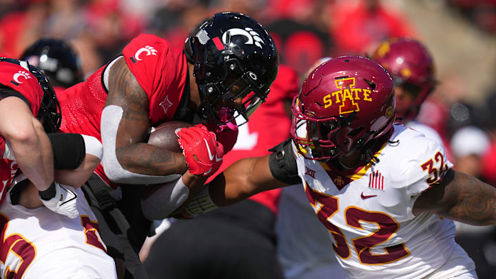 Cincinnati Bearcats running back Corey Kiner (21) carries the ball as Iowa State Cyclones linebacker Gerry Vaughn (32) defends in the first quarter during a college football game between the Iowa State Cyclones and the Cincinnati Bearcats Saturday, Oct. 14, 2023, at Nippert Stadium win Cincinnati.