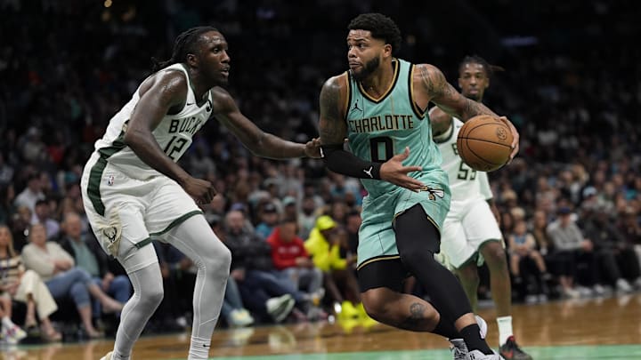 Nov 16, 2024; Charlotte, North Carolina, USA; Charlotte Hornets forward Miles Bridges (0) drives to the basket against Milwaukee Bucks forward Taurean Prince (12) during the second half at Spectrum Center. Mandatory Credit: Jim Dedmon-Imagn Images Nov 16, 2024; Charlotte, North Carolina, USA; Charlotte Hornets forward Miles Bridges (0) drives to the basket against Milwaukee Bucks forward Taurean Prince (12) during the second half at Spectrum Center. Mandatory Credit: Jim Dedmon-Imagn Images