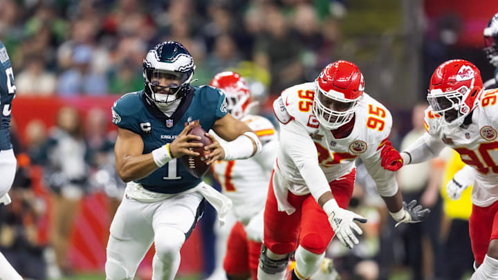 Feb 9, 2025; New Orleans, LA, USA; Philadelphia Eagles quarterback Jalen Hurts (1) is pressured by Kansas City Chiefs defensive tackle Chris Jones (95) during Super Bowl LIX at Ceasars Superdome. Mandatory Credit: Mark J. Rebilas-Imagn Images