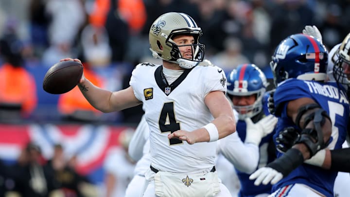 Dec 8, 2024; East Rutherford, New Jersey, USA; New Orleans Saints quarterback Derek Carr (4) drops back to pass against the New York Giants during the third quarter at MetLife Stadium. Mandatory Credit: Brad Penner-Imagn Images