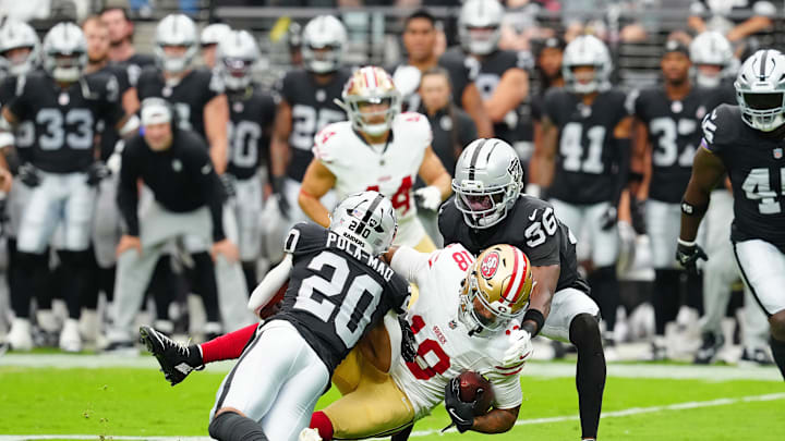 Aug 16, 2025; Paradise, Nevada, USA; San Francisco 49ers wide receiver Isaiah Hodgins (18) is tackled by Las Vegas Raiders cornerback Kyu Blu Kelly (36) and Las Vegas Raiders safety Isaiah Pola-Mao (20) during the first quarter at Allegiant Stadium. Mandatory Credit: Stephen R. Sylvanie-Imagn Images