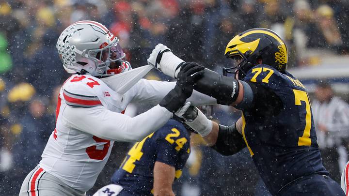Nov 29, 2025; Ann Arbor, Michigan, USA;  Michigan Wolverines offensive lineman Blake Frazier (77) blocks Ohio State Buckeyes defensive end Kenyatta Jackson Jr. (97) at Michigan Stadium. Mandatory Credit: Rick Osentoski-Imagn Images