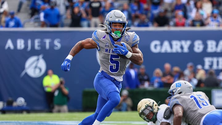 Oct 25, 2025; Memphis, Tennessee, USA; Memphis Tigers running back Sutton Smith (5) runs with the ball against the South Florida Bulls during the first quarter at Simmons Bank Liberty Stadium. Mandatory Credit: Wesley Hale-Imagn Images